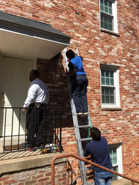 BC Exterminating team working on exterior of home